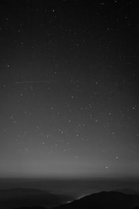 Scenic view of sea against star field at night