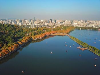 Aerial view of river amidst buildings against sky