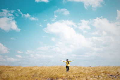 Man standing on field against sky