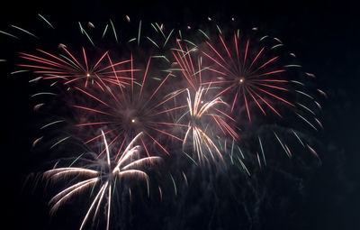 Low angle view of firework display at night