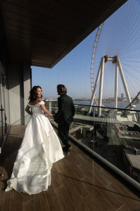 Beautiful couple running on balcony wedding