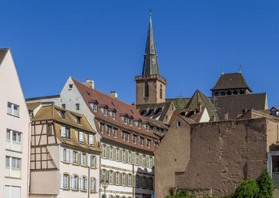 Low angle view of building against clear blue sky