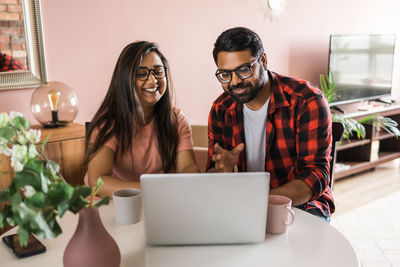 Young woman using laptop at home