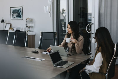 Woman working on table in office