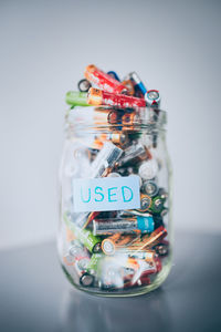 Close-up of multi colored glass jar on table