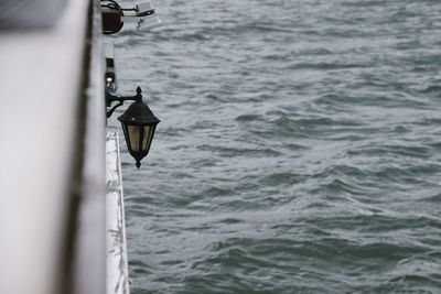 Close-up of boat hanging on sea