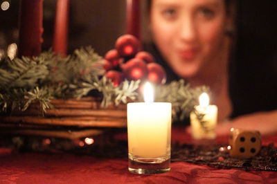 Close-up of illuminated tea light candles on table at home