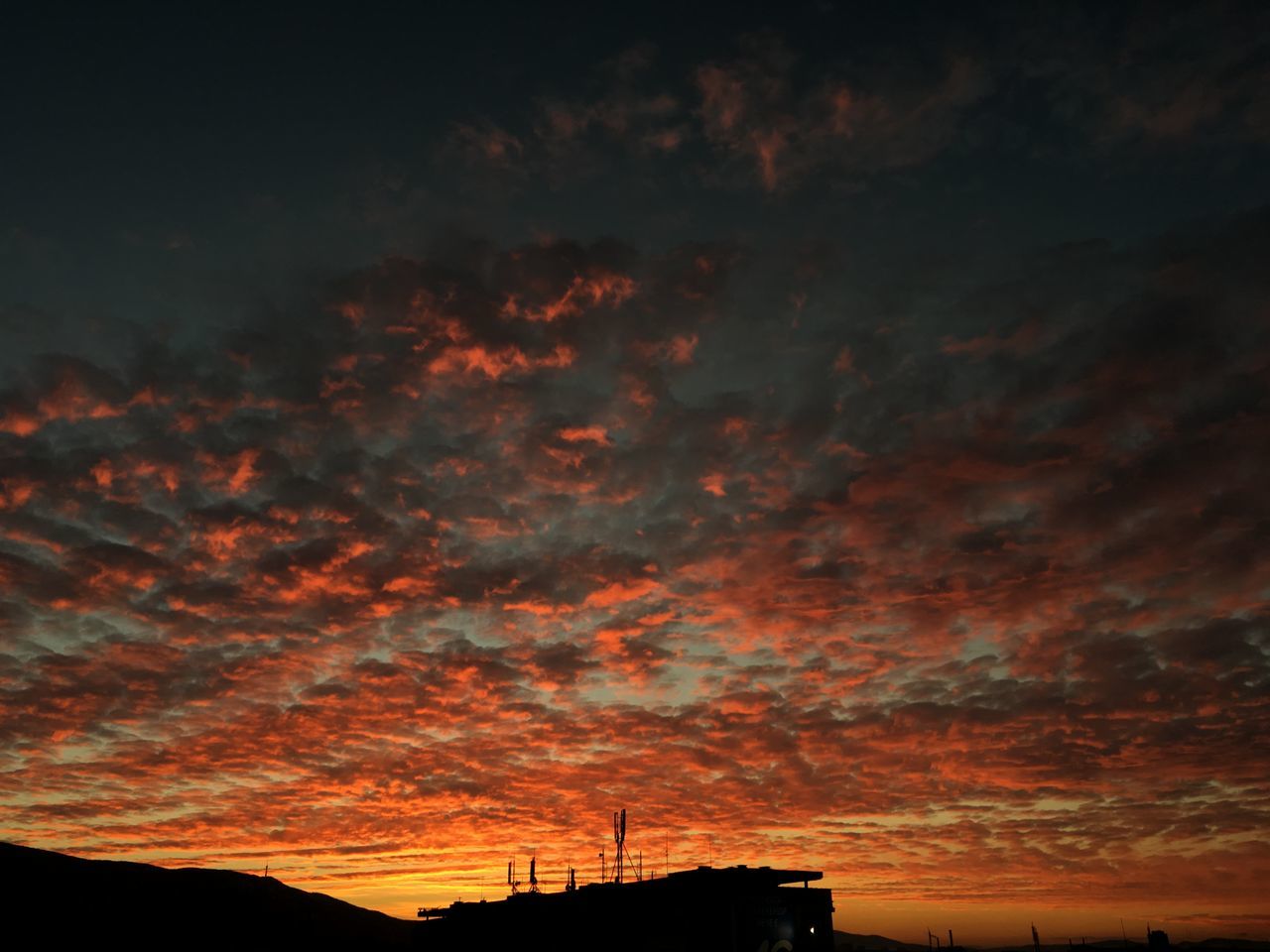 sunset, silhouette, sky, low angle view, orange color, cloud - sky, built structure, building exterior, architecture, beauty in nature, dramatic sky, scenics, nature, cloudy, cloud, tranquility, high section, dusk, outdoors, tranquil scene