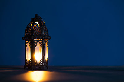 Low angle view of illuminated lights against clear sky at night