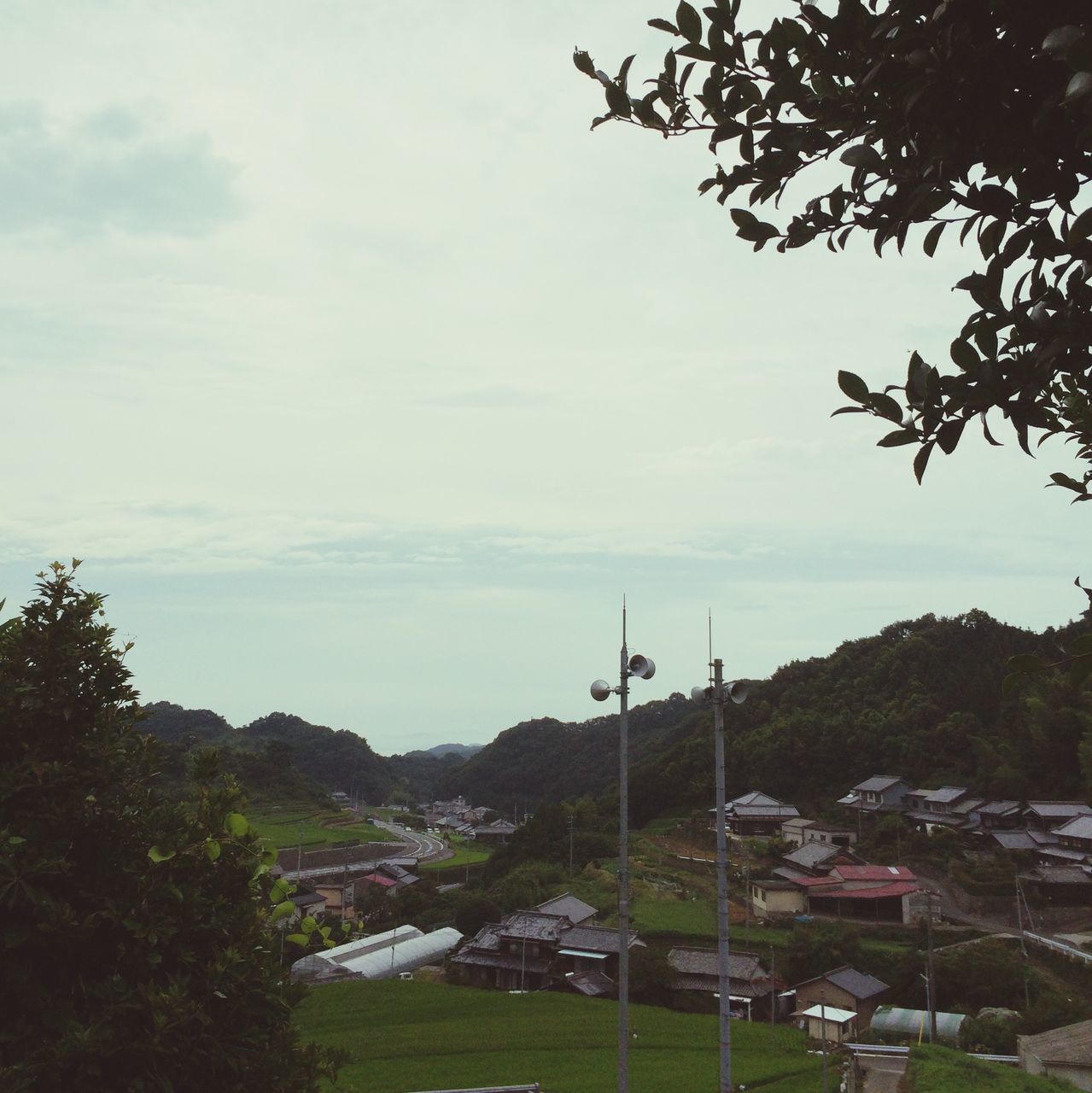 sky, tree, built structure, building exterior, architecture, cloud - sky, mountain, cloud, nature, cloudy, house, scenics, landscape, tranquility, beauty in nature, water, tranquil scene, city, river, day