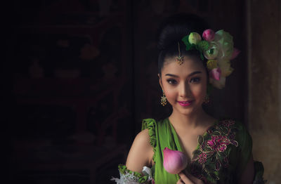 Portrait of beautiful woman wearing flowers on hair