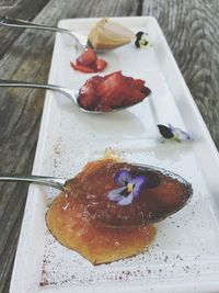 High angle view of food with spoons in plate on table