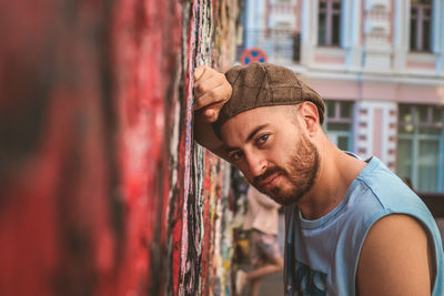 Portrait of young man against wall