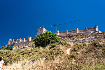 Low angle view of historic building against clear blue sky