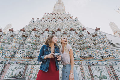 Happy women at temple in city