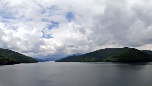 Scenic view of lake and mountains against sky