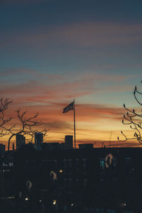 Silhouette buildings against sky during sunset