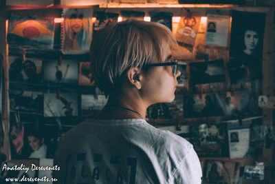 Portrait of young woman standing by store