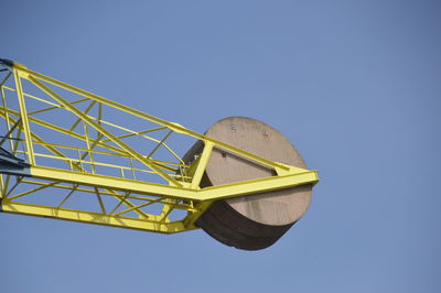 Low angle view of yellow umbrella against clear blue sky