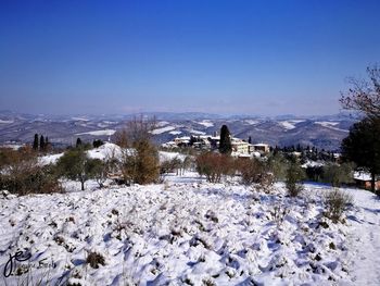 Scenic view of landscape against clear sky during winter