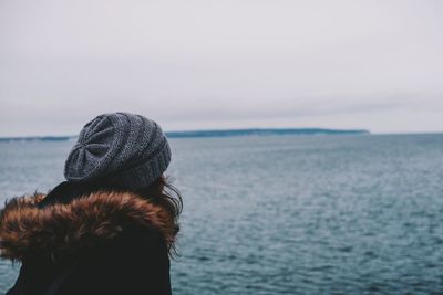 Close-up of woman against sea against sky