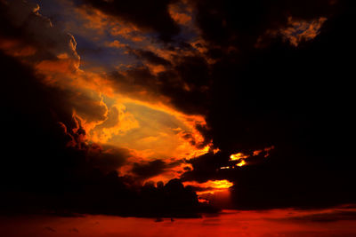 Scenic view of beach against sky at sunset