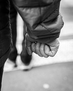 Midsection of couple holding hands