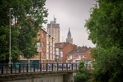 Canal amidst buildings against sky