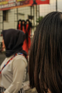 Rear view of people walking in city