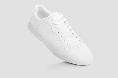 Close-up of shoes over white background
