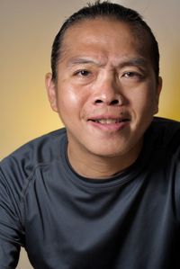 Close-up portrait of mature man against colored background
