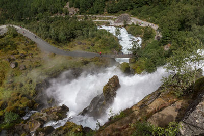 High angle view of waterfall along trees