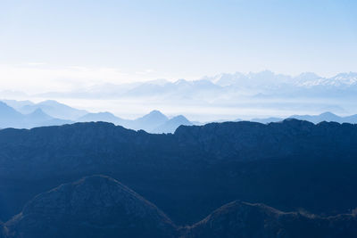 Scenic view of silhouettes of mountains in the morning mist. picos de europa, asturias