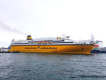 Yellow ship in water against clear sky