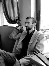 Young man sitting on seat