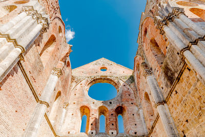 Low angle view of historical building against blue sky