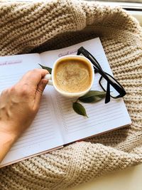 Hand holding coffee cup