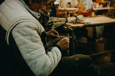 Rear view of man working in workshop