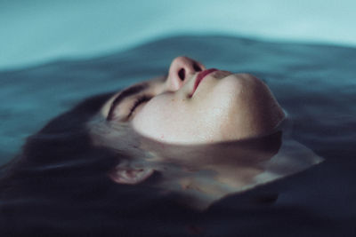 Close-up of young woman in bathtub