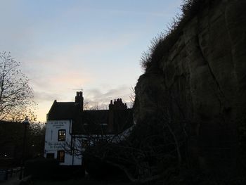 Low angle view of building against sky at sunset