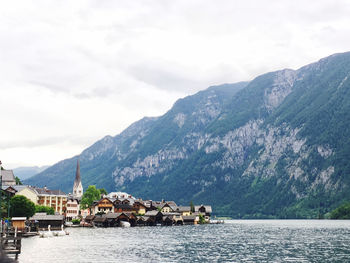 Scenic view of buildings and mountains against sky