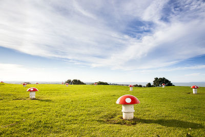 View of field against cloudy sky