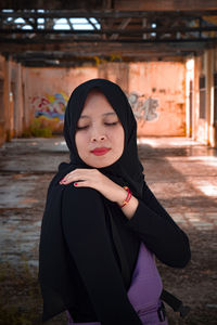 Portrait of beautiful young woman standing outdoors