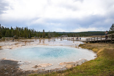 Tourists exploring silex spring in yellowstone national park during vacation