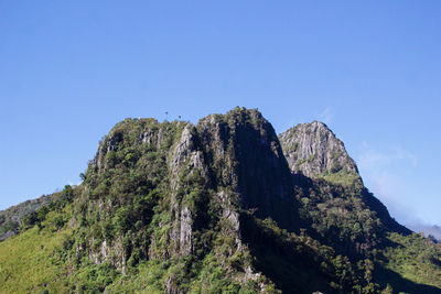 Scenic view of mountains against clear blue sky