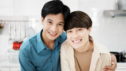 Portrait asian homosexual gay couple smile happily to the camera. lovely young lgbt laugh