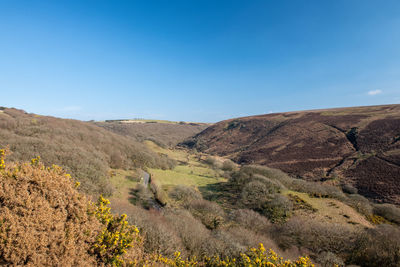 Scenic view of mountains against clear blue sky