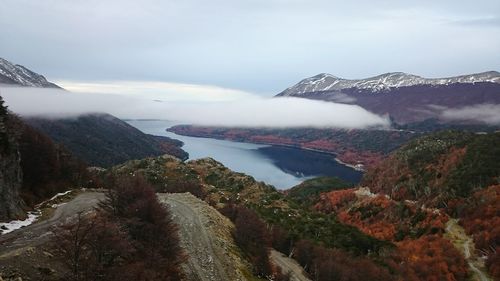 Scenic view of sea and mountains against sky