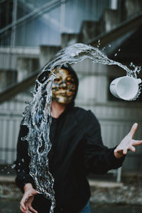 Midsection of man standing against fountain