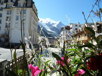 Scenic view of buildings and mountains against sky